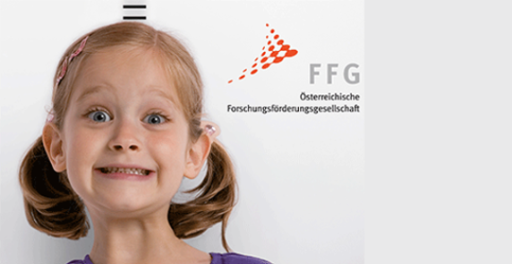 Mädchen mit FFG-Logo im Hintergrund